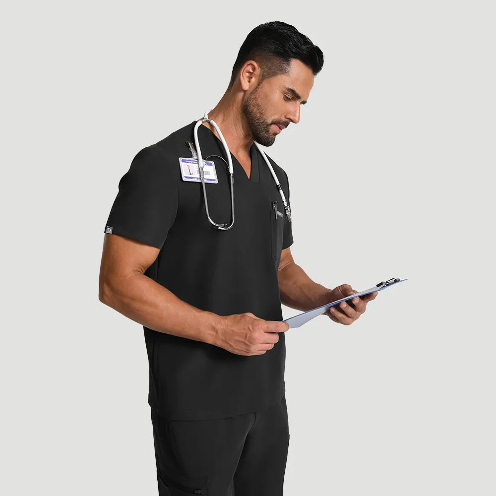KungFu Scrubs men’s black scrub set in use with stethoscope and clipboard